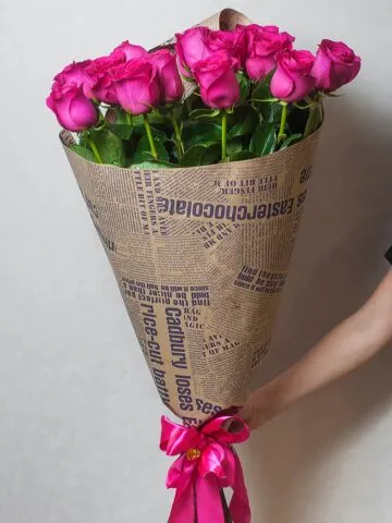 Bouquet of pink meter roses in kraft